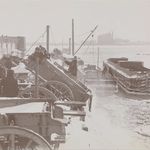 Blizzard of 1899. "Snow removal workers dumping loads of snow to a river."